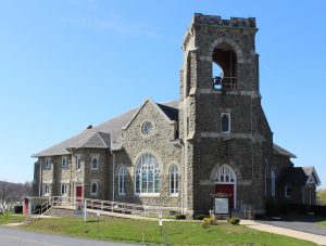 Full-color photo of church with blue sky